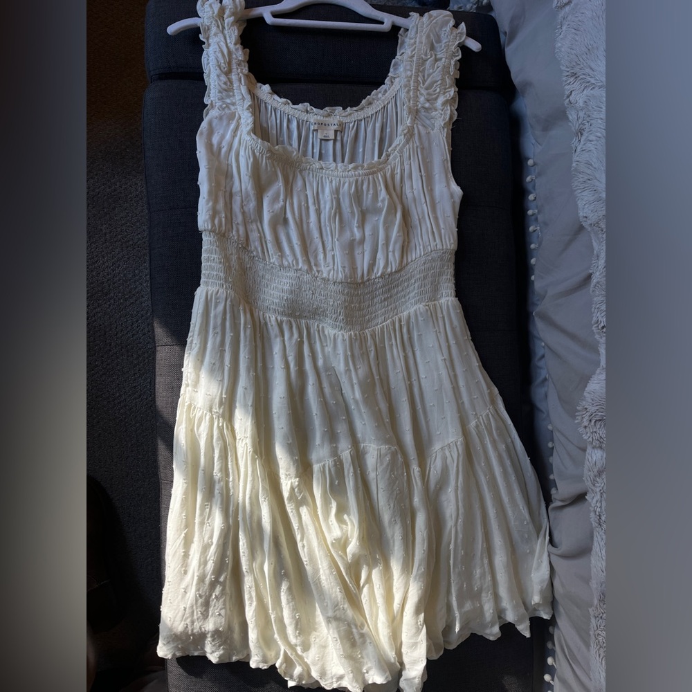 White flowy mini dresss with ruffled sleeves. Perfect summer dress!